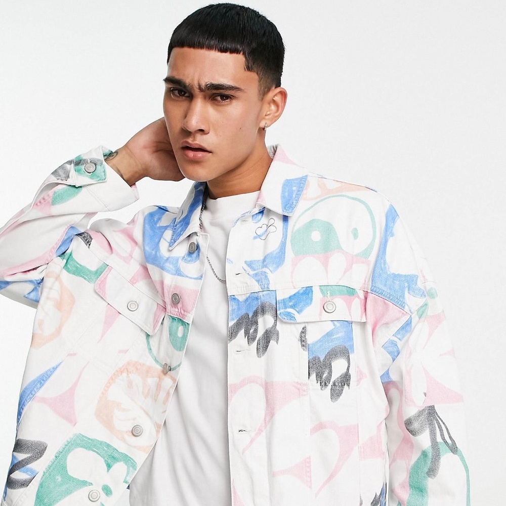 Denim with graffiti print in white .